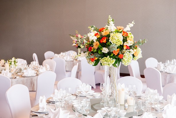 Hanoi hotel wedding table arrangment with orange flowers